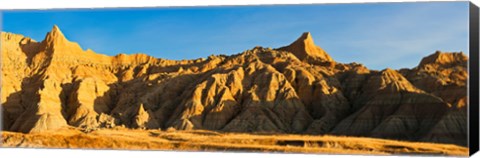 Framed Sculpted sandstone spires in golden light, Saddle Pass Trail, Badlands National Park, South Dakota, USA Print