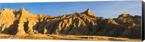 Framed Sculpted sandstone spires in golden light, Saddle Pass Trail, Badlands National Park, South Dakota, USA Print