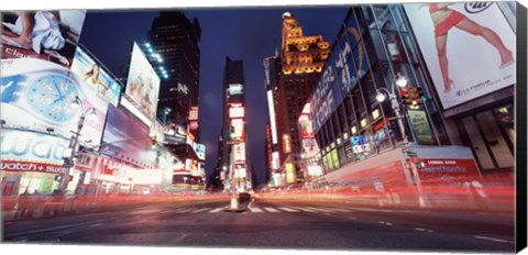 Framed Low angle view of sign boards lit up at night, Times Square, New York City, New York, USA Print