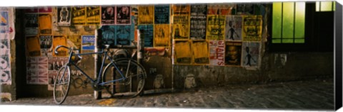 Framed Bicycle leaning against a wall with posters in an alley, Post Alley, Seattle, Washington State, USA Print