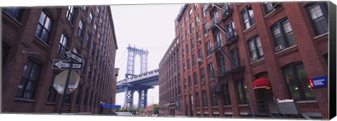 Framed Low angle view of a suspension bridge viewed through buildings, Manhattan Bridge, Brooklyn, New York City, New York State, USA Print