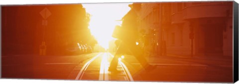 Framed Side profile of a person crossing the cable car tracks at sunset, San Francisco, California, USA Print