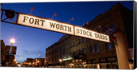Framed Signboard over a road at dusk, Fort Worth Stockyards, Fort Worth, Texas, USA Print