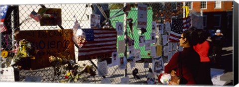 Framed Side profile of a woman standing in front of chain-link fence at a memorial, New York City, New York State, USA Print