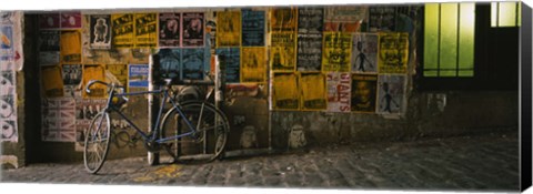 Framed Bicycle leaning against a wall with posters in an alley, Post Alley, Seattle, Washington State, USA Print