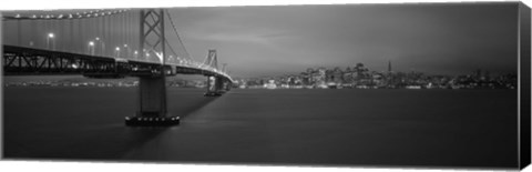 Framed Low angle view of a suspension bridge lit up at night, Bay Bridge, San Francisco, California, USA Print