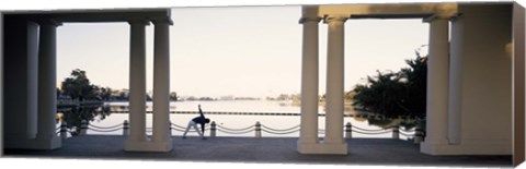 Framed Person stretching near colonnade, Lake Merritt, Oakland, Alameda County, California, USA Print