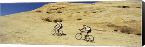 Framed Side profile of two men mountain bilking on rocks, Slickrock Trail, Moab, Utah, USA Print