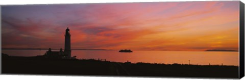 Framed Silhouette of a lighthouse at sunset, Scotland Print