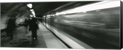 Framed Subway train passing through a subway station, London, England Print