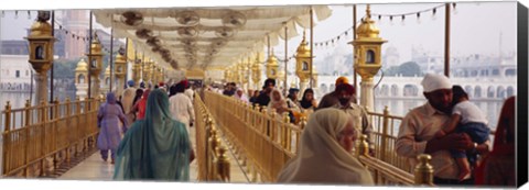 Framed Group of people walking on a bridge over a pond, Golden Temple, Amritsar, Punjab, India Print