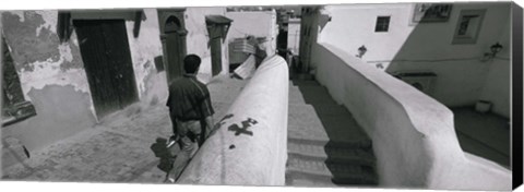 Framed Rear view of a man walking in front of a building, Casaba, Algiers, Algeria Print