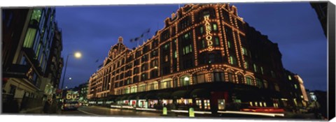 Framed Low angle view of buildings lit up at night, Harrods, London, England Print