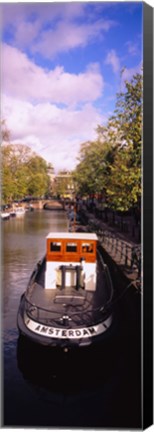 Framed Tourboat docked in a channel, Amsterdam, Netherlands Print