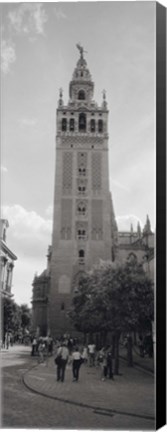 Framed Group of people walking near a church, La Giralda, Seville Cathedral, Seville, Seville Province, Andalusia, Spain Print