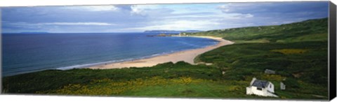 Framed Birds-eye view of sea, white stone cottage, Northern Ireland. Print