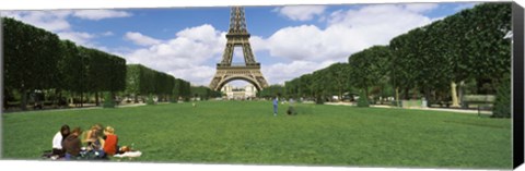 Framed Tourists sitting in a park with a tower in the background, Eiffel Tower, Paris, Ile-de-France, France Print