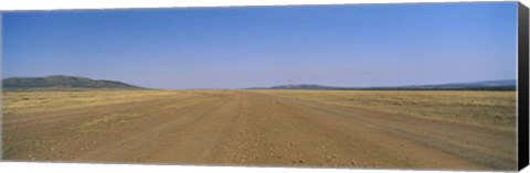 Framed Dirt road passing through a landscape, Masai Mara National Reserve, Great Rift Valley, Kenya Print