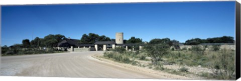 Framed Road leading towards the entrance of a rest camp, Okaukuejo, Etosha National Park, Kunene Region, Namibia Print