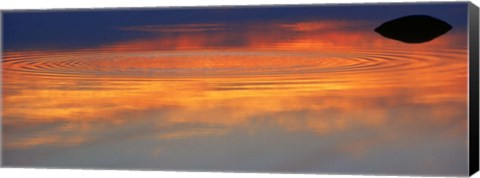 Framed Reflection of clouds with circular ripples spreading outward across glassy lake waters at sunset Print