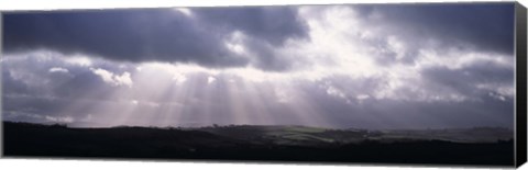 Framed Sunbeams radiating through dark clouds over rolling hills, Dartmoor, Devon, England Print