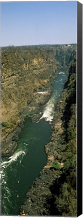 Framed Kayakers paddle down the Zambezi gorge away from the Victoria Falls, Zambia Print