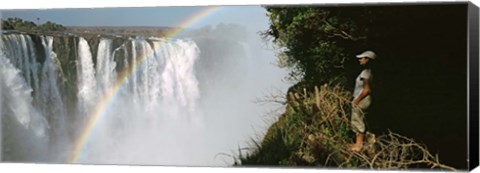 Framed Woman looking at a rainbow over the Victoria Falls, Zimbabwe Print