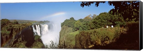 Framed Tourists at a viewing point looking at the rainbow formed over Victoria Falls, Zimbabwe Print