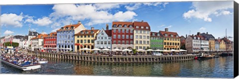 Framed Tourists in a tourboat with buildings along a canal, Nyhavn, Copenhagen, Denmark Print