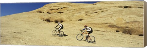 Framed Side profile of two men mountain bilking on rocks, Slickrock Trail, Moab, Utah, USA Print