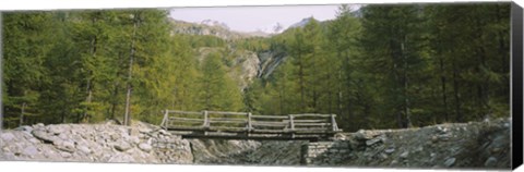 Framed Wooden footbridge across a stream in a mountain range, Switzerland Print