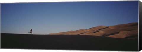 Framed USA, Colorado, Great Sand Dunes National Monument, Runner jogging in the park Print