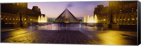 Framed Museum lit up at night with ghosted image of three men, Louvre Museum, Paris, France Print