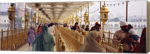 Framed Group of people walking on a bridge over a pond, Golden Temple, Amritsar, Punjab, India Print