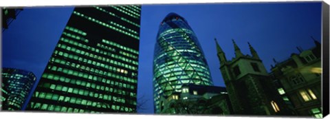 Framed Low angle view of buildings lit up at night, Sir Norman Foster Building, Swiss Re Tower, London, England Print