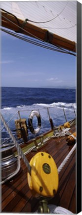 Framed Detail of the mainsheet block of a wooden sailboat in the sea Print