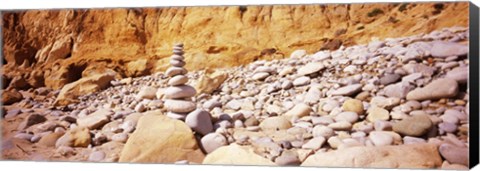 Framed Stack of stones on the beach, California, USA Print