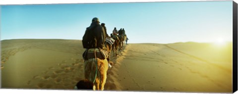 Framed Row of people riding camels through the desert, Sahara Desert, Morocco Print