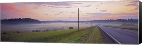 Framed Country road and telephone lines splitting farmlands at dawn, Finland Print