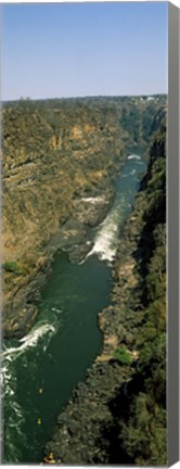 Framed Kayakers paddle down the Zambezi gorge away from the Victoria Falls, Zambia Print