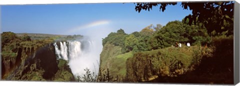 Framed Tourists at a viewing point looking at the rainbow formed over Victoria Falls, Zimbabwe Print