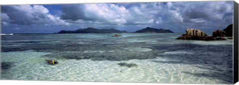 Framed Snorkeler in the clean waters on Anse Source d&#39;Argent beach, La Digue Island, Seychelles Print