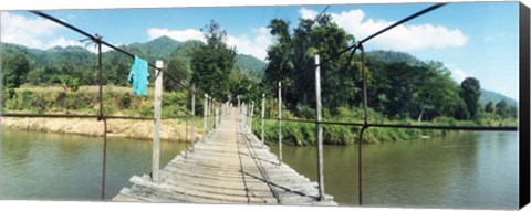 Framed Old wooden bridge across the river, Chiang Mai Province, Thailand Print