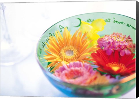 Framed Pink, orange and yellow flowers floating in a blue bowl Print