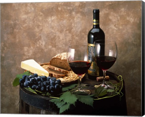 Framed Still life of wine bottle, wine glasses, cheese and purple grapes on top of barrel Print