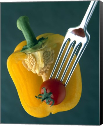 Framed Close up of half yellow pepper with cherry tomato in center on fork tines Print