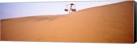 Framed Low angle view of a woman carrying panniers, Mui Ne, Vietnam Print