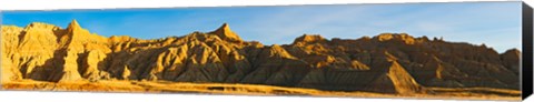 Framed Rock formations on a landscape in golden light, Saddle Pass Trail, Badlands National Park, South Dakota, USA Print