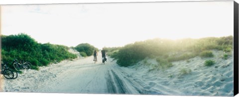 Framed Rear view of a couple cycling along a beach trail, Fort Tilden, Queens, New York City, New York State, USA Print