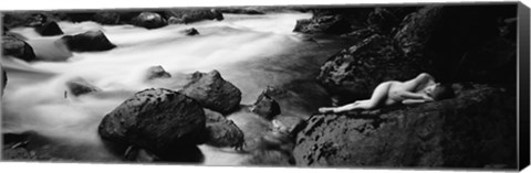 Framed Side profile of a naked woman lying on a rock Print